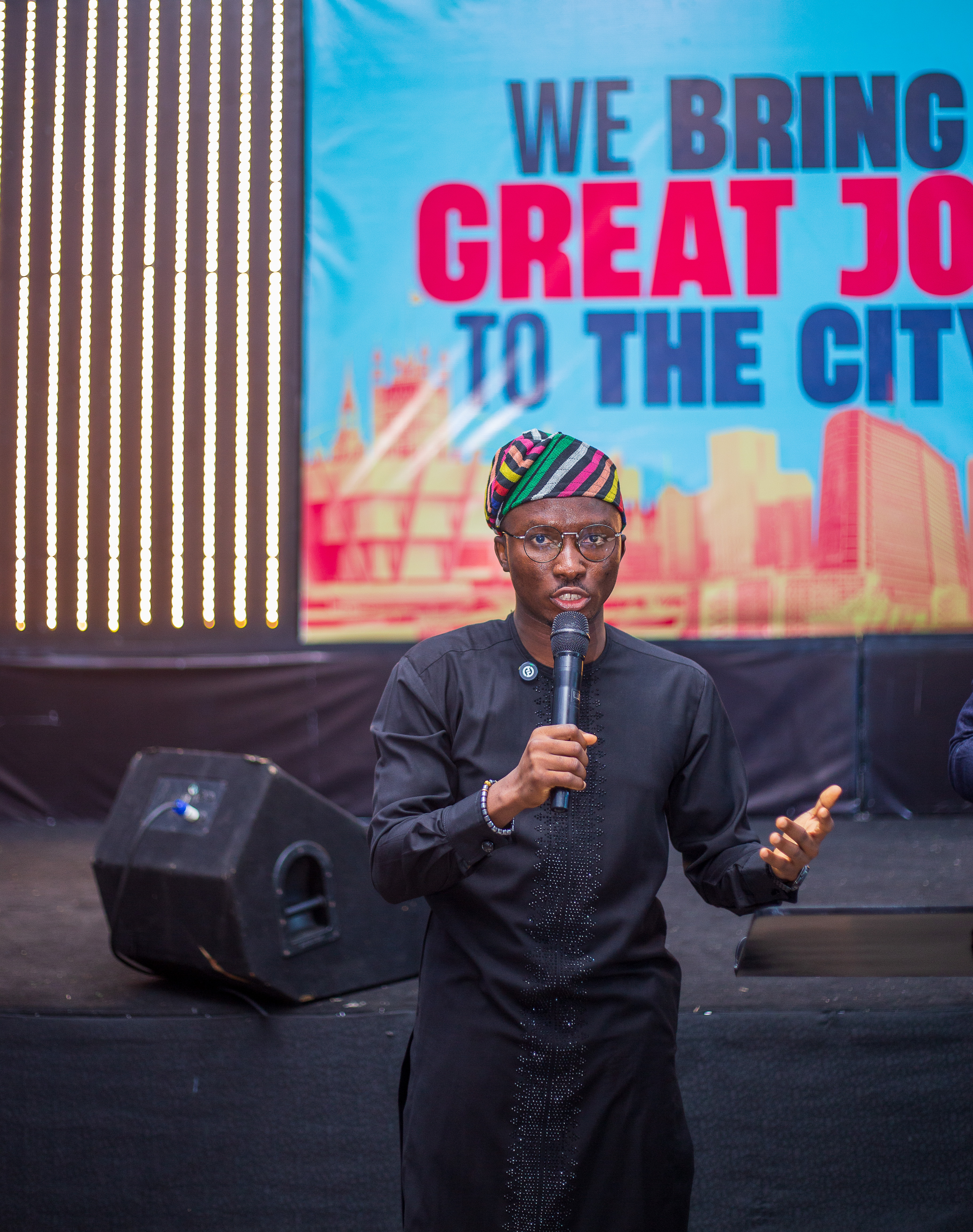 Samuel Adegboyega speaking on stage